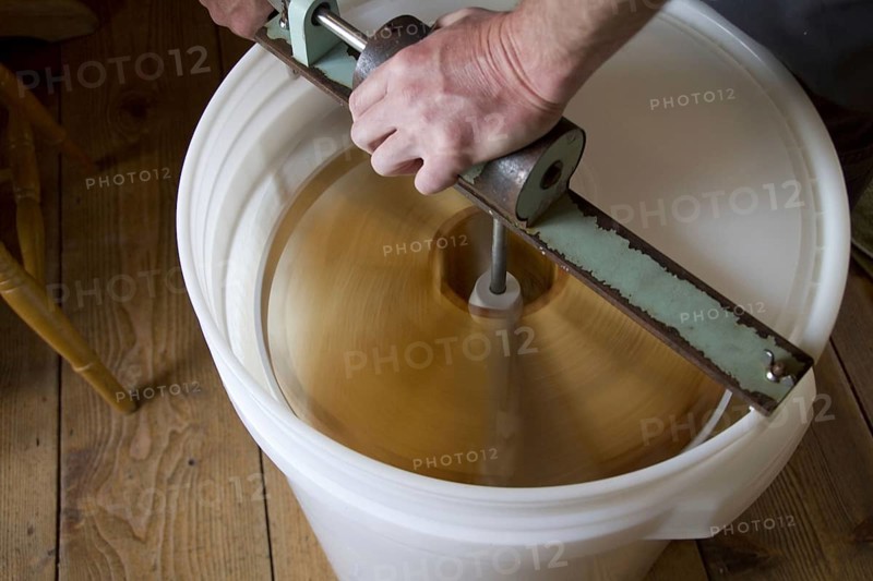 The honeycomb frames are placed in a centrifugal drum and then spun at high speed to separate the honey from the combs