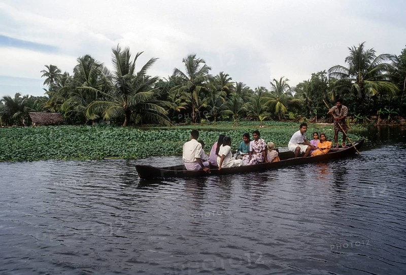 A boat man taking people to their village in a small boat