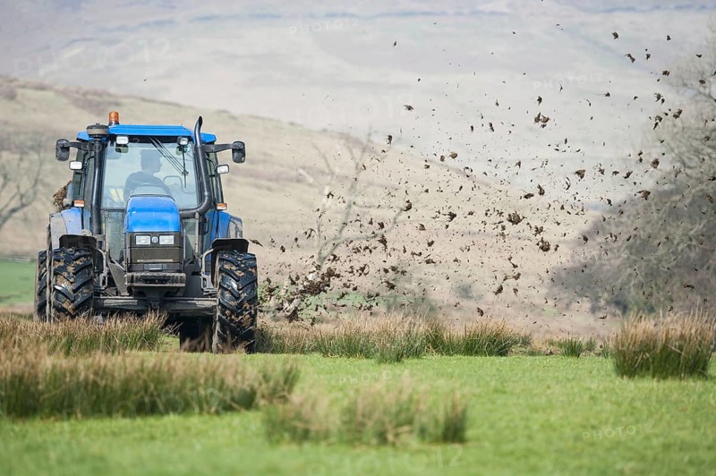 New Holland TS115 tractor with muckspreader