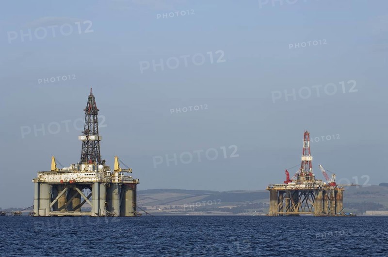 Oil rigs moored in sea near coast