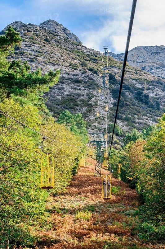 Ropeway Cabinovia Monte Capanne with open gondola Ropeway gondola standing gondola on mountain Monte Capanne