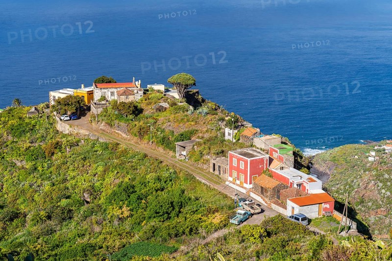 Houses in the village of El Tablado and cliffs on the Atlantic Ocean