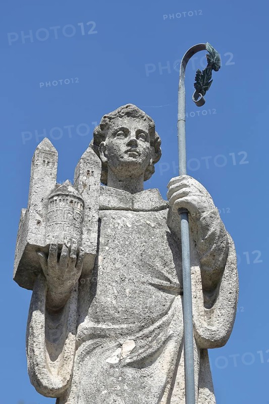 Saint St. Castor with bishop's crook and carrying miniature of collegiate church and Moselle cathedral in hand at Lindenplatz in Karden