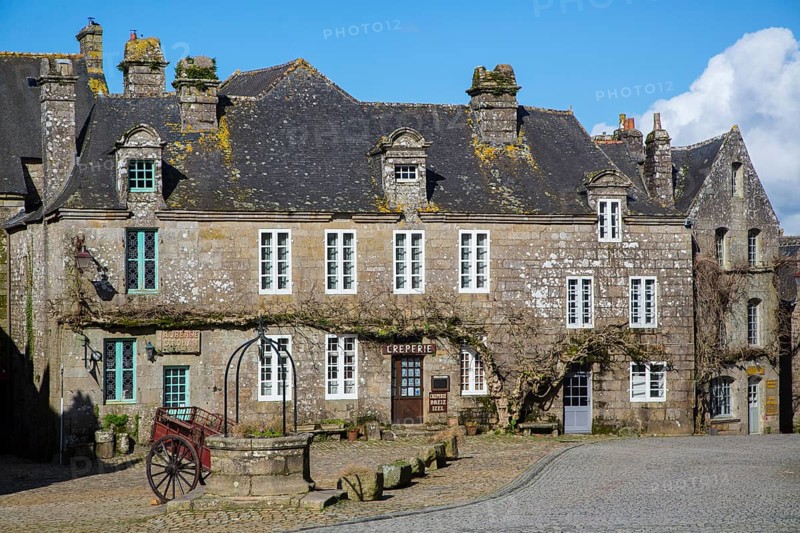 Village square with old horse-drawn cart and fountain