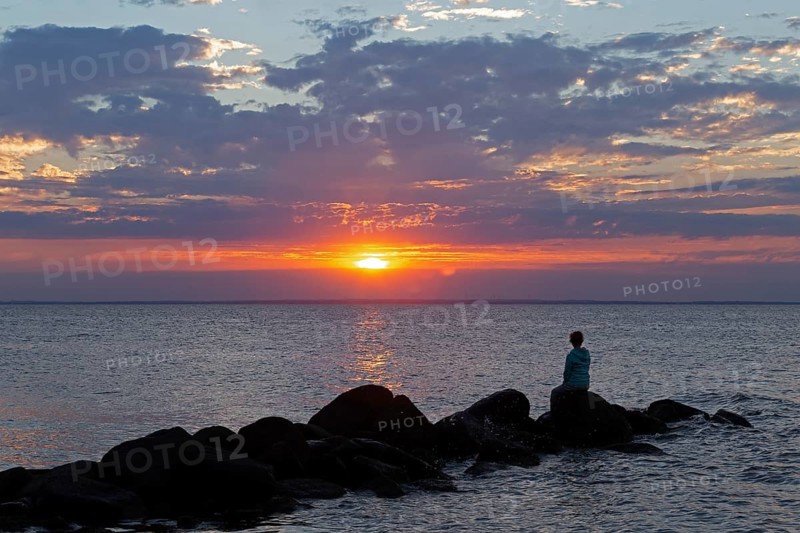 Woman sitting on stones