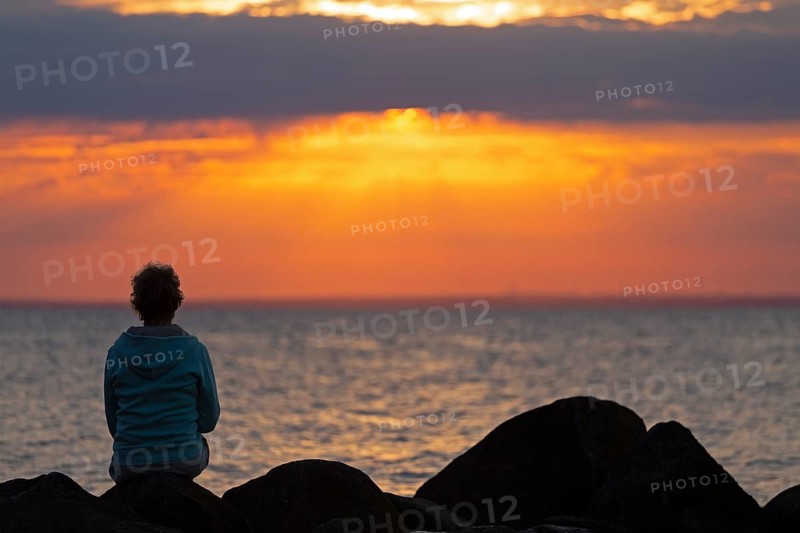 Woman sitting on stones