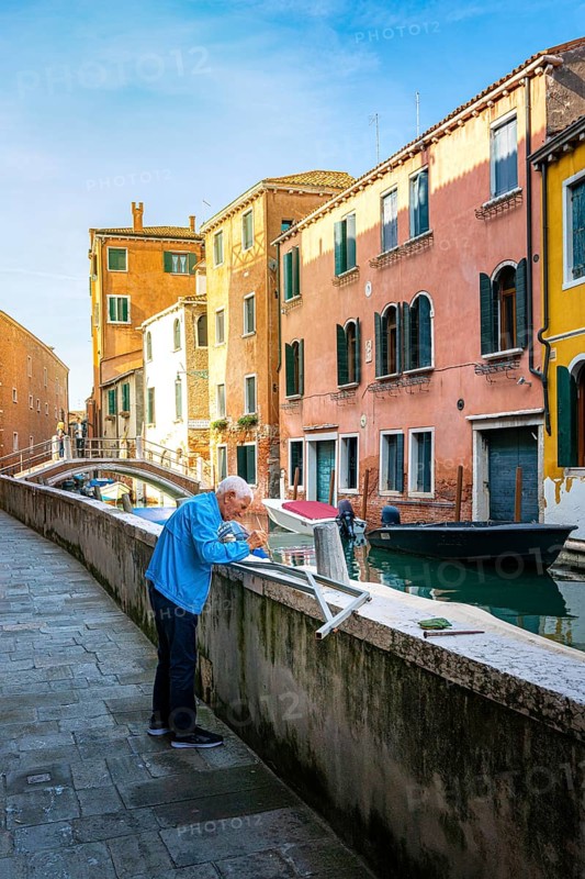 Senior doing handicraft work in the lagoon city of Venice
