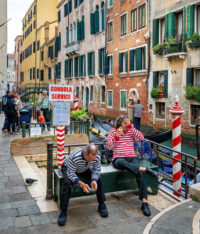 Gondolliers in the lagoon city waiting for tourists
