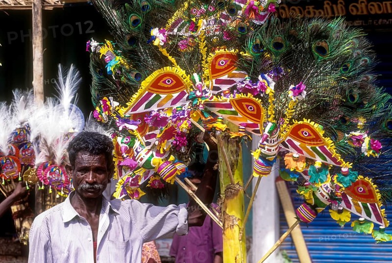 A man holding a decorated plantain in a village festival