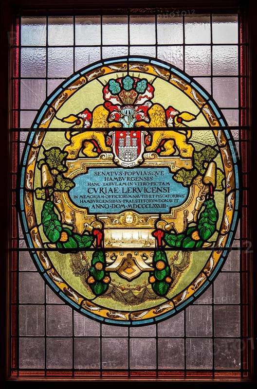 Leaded glass in the town hall shows the coat of arms of Hamburg and insignia of the former Hanseatic League