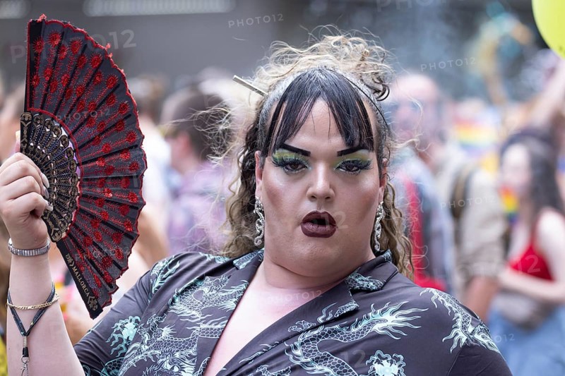Made-up transvestite with fan at the CSD parade