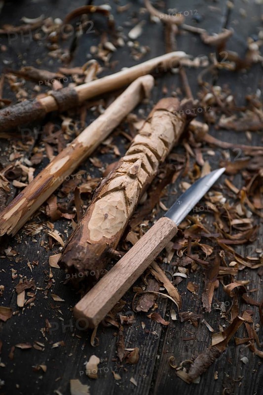 Carved crochet hook and face of an old man