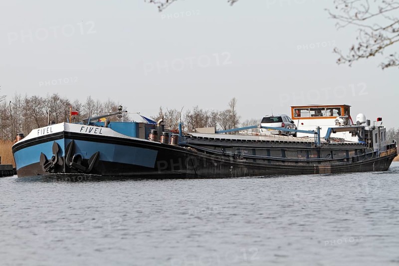 Fully loaded Dutch cargo ship Fivel on the river Peene