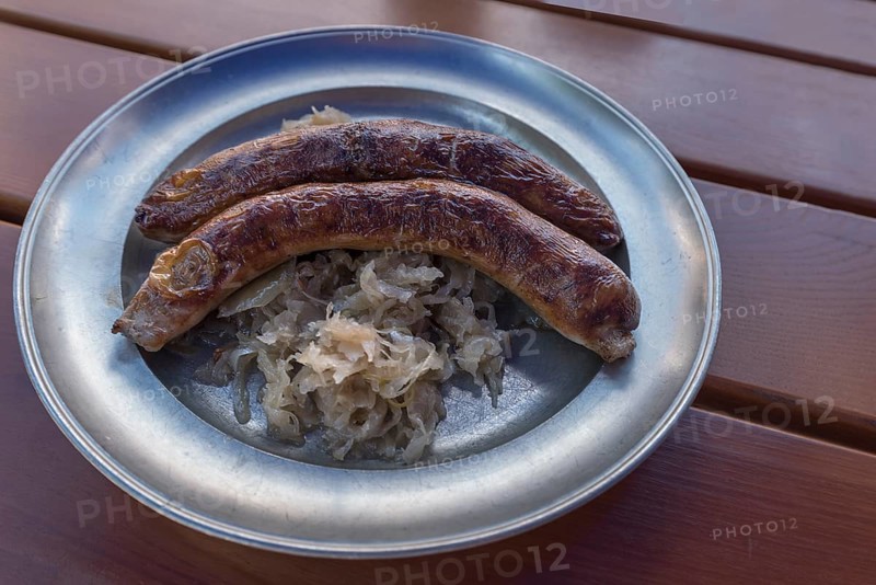 Pewter plate with two Franconian sausages and sauerkraut