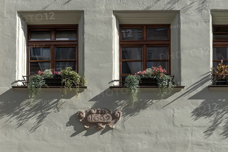 Window with year of construction 1697 on historic residential and commercial building