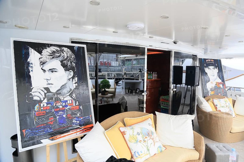 Sofas and paintings with racing drivers and racing cars
