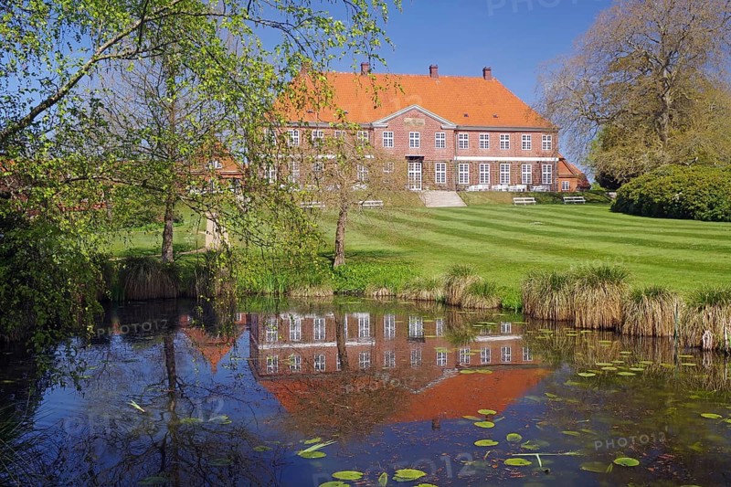 Manor house reflected in a pond