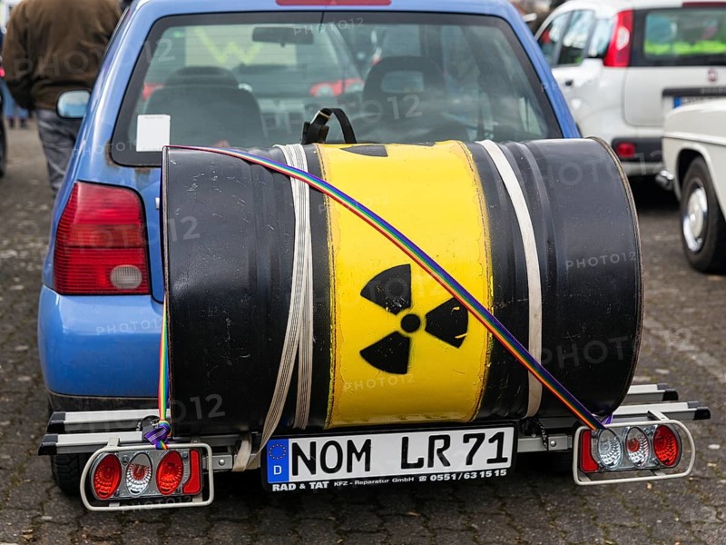Metal barrel with sign for radioactivity on bicycle rack