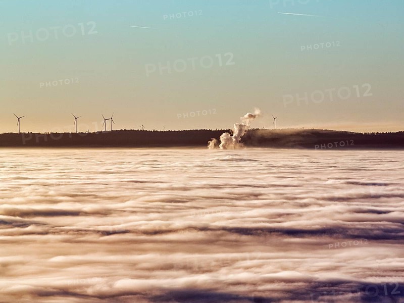 Three columns of steam rising from cloud cover
