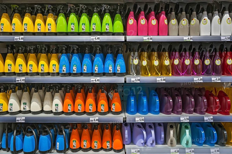 Shelf with spray bottles and watering cans