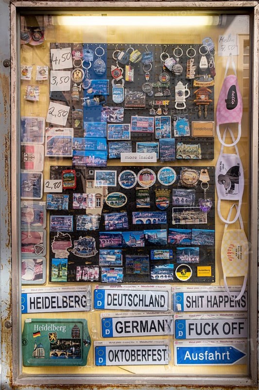 Signs and knick-knacks for tourists in a shop window of a shop in the old town of Heidelberg. The shop is closed due to the Corona pandemic
