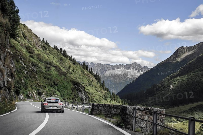 Porsche 911 GT3 sports car on well-built Alpine road from Sustenpass to Wassen