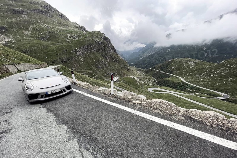 Supercar sports car Porsche 911 GT3 on pass road in Alps to Colle del Nivolet