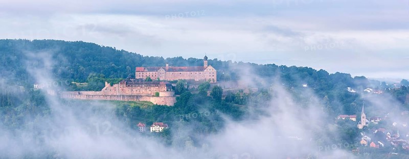 View of Plassenburg Castle and Kulmbach in the morning mist