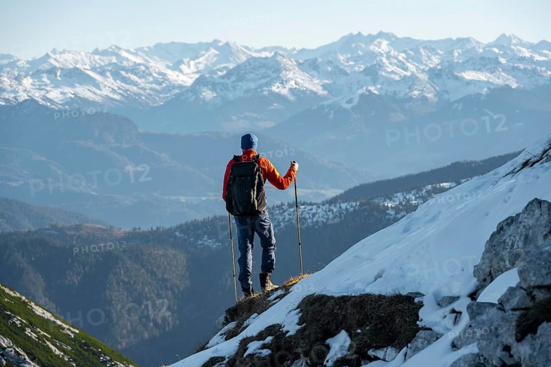 Mountaineers on the rocky summit ridge with the first snow in autumn