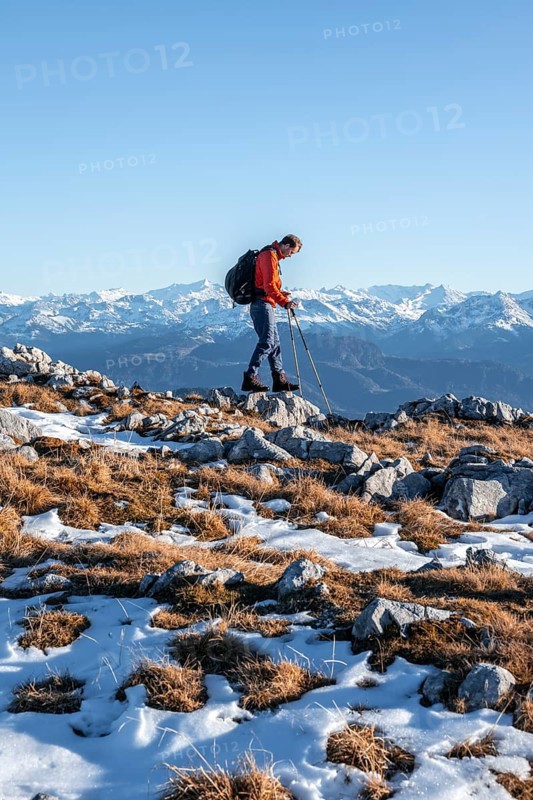 Mountaineer hiking in front of mountain panorama