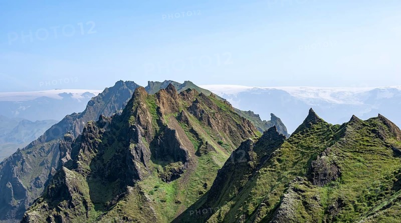 Pointed green mountain peaks on the ridge of Tindfjoell