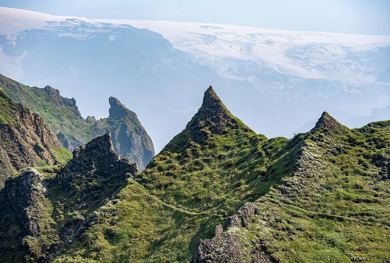 Pointed green mountain peaks on the ridge of Tindfjoell