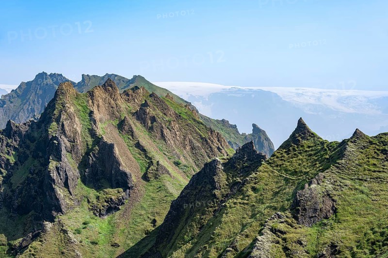Pointed green mountain peaks on the ridge of Tindfjoell