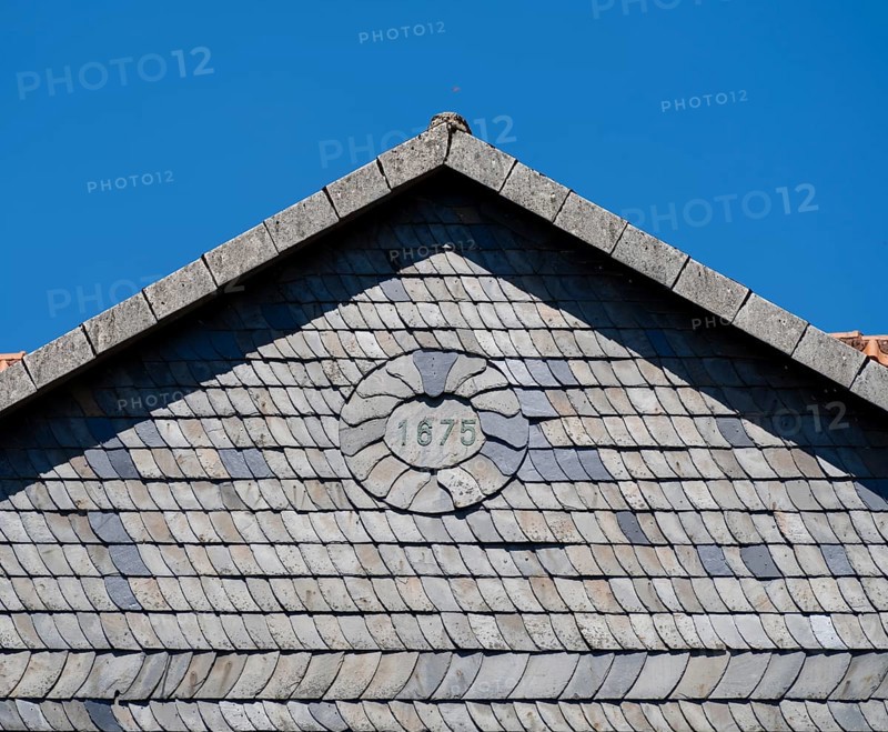 Facade covered with slate shingles of a former restaurant at the Auerhahnteich