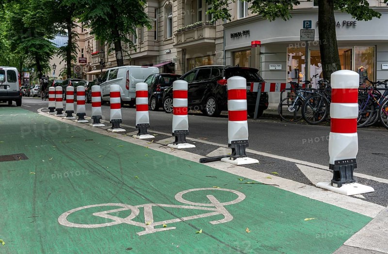 Bicycle lane with green marking and safety bollards
