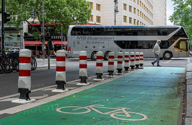 Bicycle lane with green marking and safety bollards