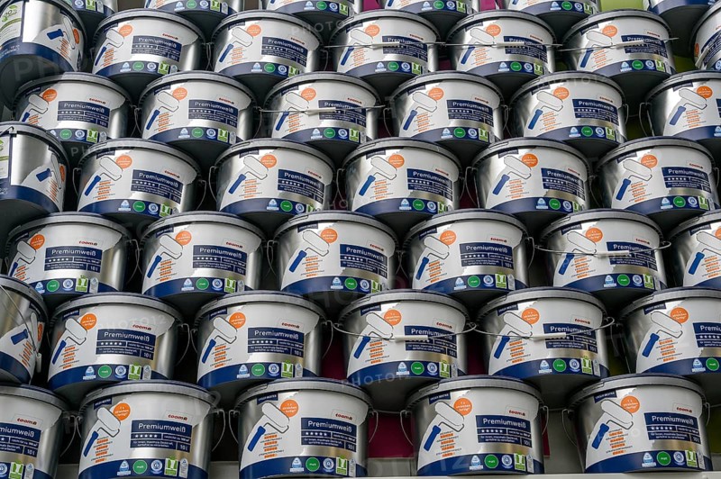 Stacked paint buckets with premium white in a DIY store