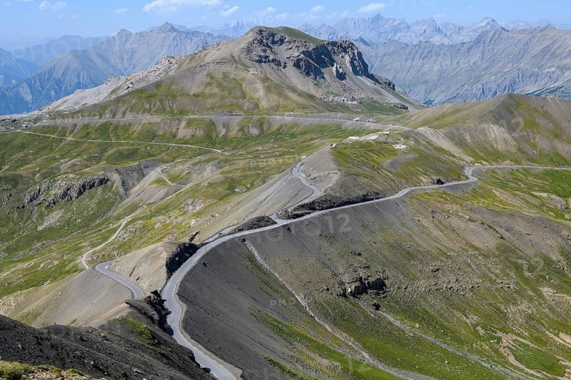 View from Cime de la Bonette on high alpine mountain landscape with alpine pass Col de la Bonette in the middle