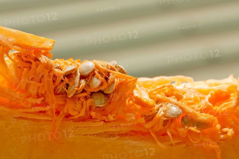 Macro shot of sliced pumpkin with pulp and seeds