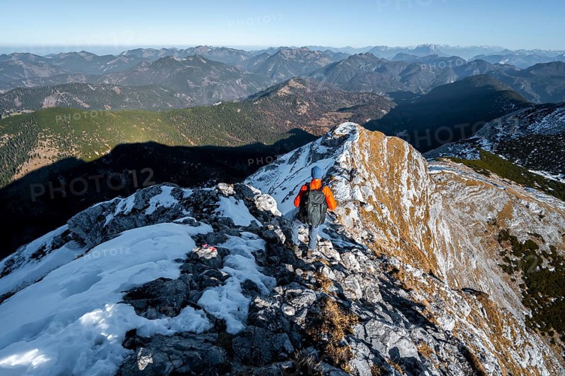 Climbers on the summit ridge with first snow in autumn
