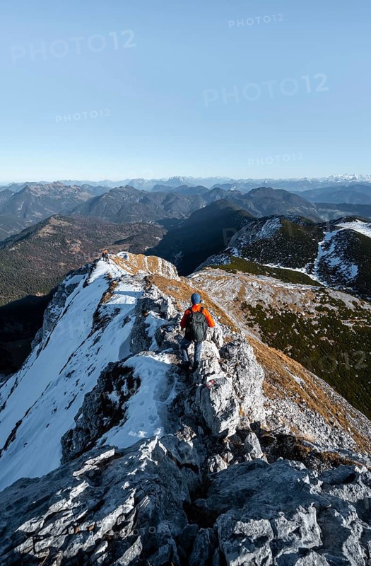 Climbers on the summit ridge with first snow in autumn