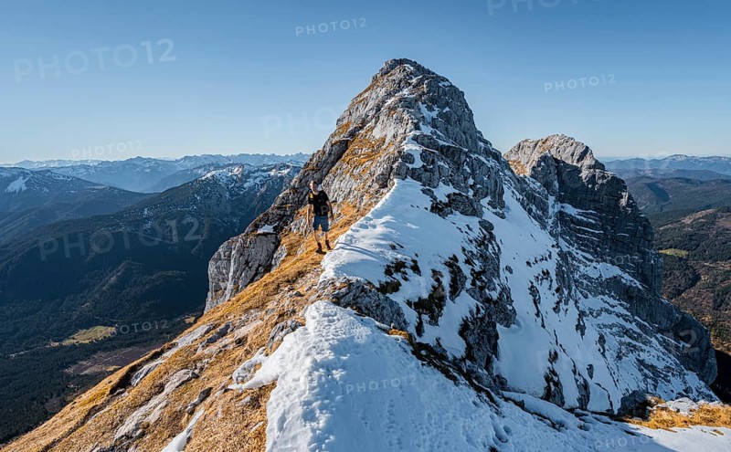 Climbers on the summit ridge with first snow in autumn
