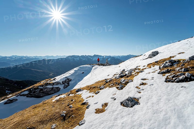 Hiker next to a cairn