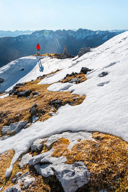 Mountaineer next to a cairn