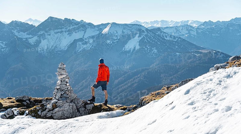 Mountaineer next to a cairn