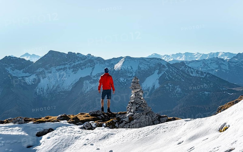 Mountaineer next to a cairn
