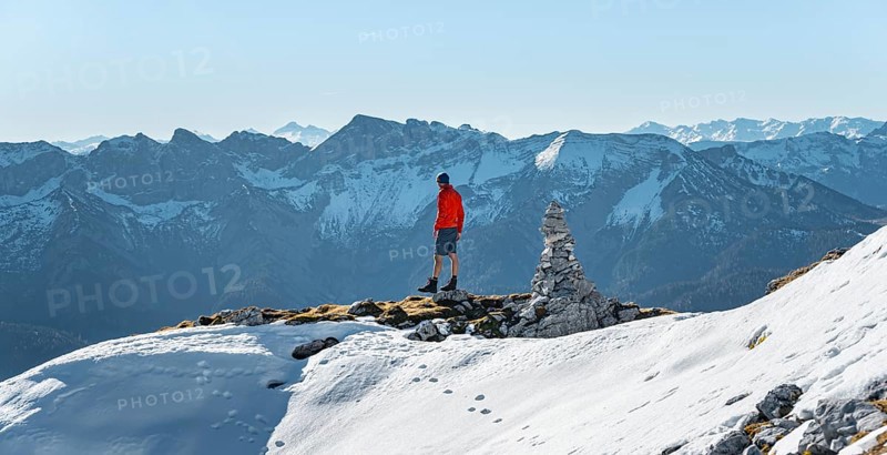 Mountaineer next to a cairn