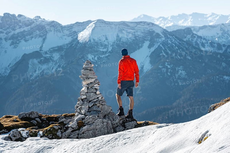 Mountaineer next to a cairn