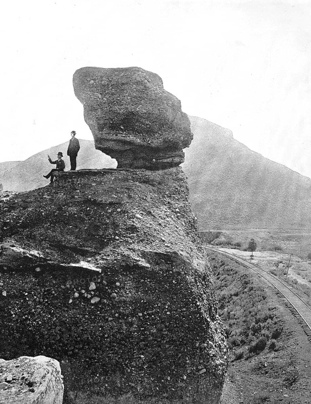 Men next to the rock formation