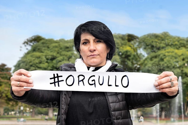 Woman holding an #orgullo or #pride sign. LGBT Concept